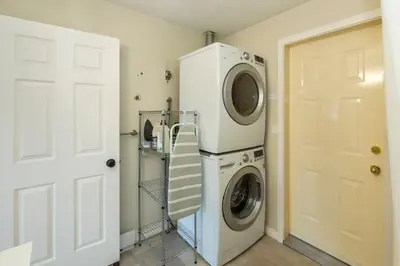 a washer and dryer in a room with a door at NN - The Summit - Copper Ridge 1-bed 1-bath in Whitehorse