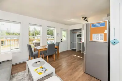 a living room with a refrigerator and a table at NN - The Summit - Copper Ridge 1-bed 1-bath in Whitehorse