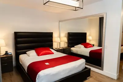 a bedroom with two beds and a large mirror at Mountain View Hope Motel in Hope