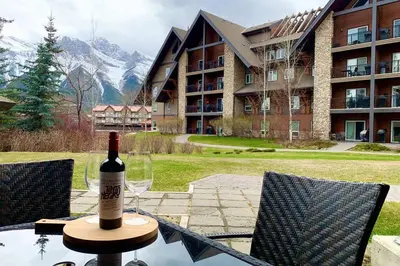 a bottle of wine sitting on top of a table at Mountain Retreat, Pool & Hot Tub, BBQ, Patio, King Bed, Sleeps 6! in Canmore