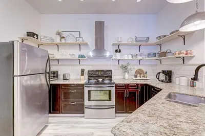 a kitchen with a stainless steel refrigerator and stove at Mountain Retreat, Pool & Hot Tub, BBQ, Patio, King Bed, Sleeps 6! in Canmore
