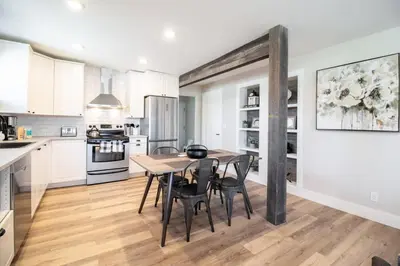 a kitchen with a table and chairs in a room at NN - Flats on 4th #1 - Downtown 2-bed 2-bath in Whitehorse