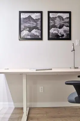 a white desk in a room with two pictures on the wall at NN - Eddy #1 - Whistlebend 3-bed 2 5-bath in Whitehorse