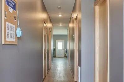 a hallway with doors and a long hallway with a hallwayngth at NN - The Kluane - Whistlebend 3-bed 2-bath in Whitehorse