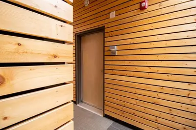 a wooden wall with a door in a room at NN - Park View #1 - Downtown 2-bed 2-bath in Whitehorse