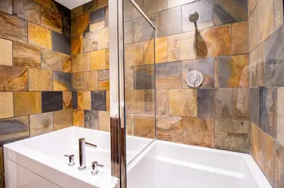 a bathroom with a white tub and a shower at NN - Park View #2 - Downtown 2-bed 2-bath in Whitehorse