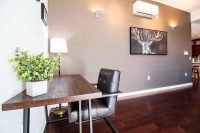 a dining room with a wooden table and black chairs at NN - Park View #2 - Downtown 2-bed 2-bath in Whitehorse