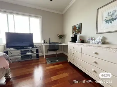a living room with a television and a dresser at independent entrance cozy room with private bathroom close to YVR Richmond in Richmond