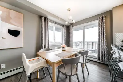 a dining room with a table and chairs at Peaceful Oasis Condo, AC, Top Floor, Secure UG Parking, Balcony, King Bed! in Edmonton
