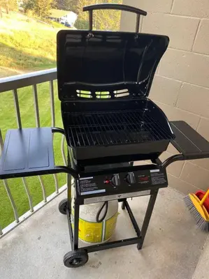 a grill sitting on a cart on a porch at Lovely 2 bedroom condo, 2 minute walk fr downtown in Invermere