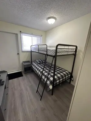 a small room with two bunk beds in it at Lovely 2 bedroom condo, 2 minute walk fr downtown in Invermere