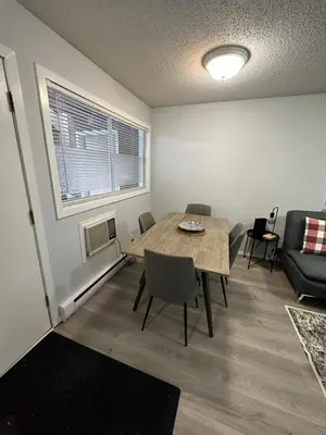 a living room with a table and a couch at Lovely 2 bedroom condo, 2 minute walk fr downtown in Invermere