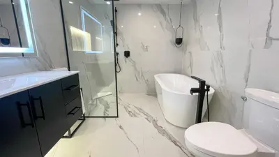 a bathroom with a shower and a toilet and a sink at 2BR plus Loft, Modern and Spacious, Hot Tub and Sauna, Private Balcony, Fireplace in Whistler