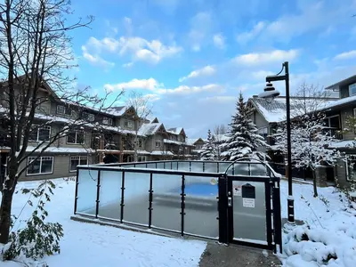 a building in a yard covered in snow at Perfect family 2-bed Condo with hot tub in Dead Man's Flats