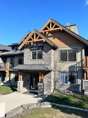 a house with a wooden roof on top of it at Perfect family 2-bed Condo with hot tub in Dead Man's Flats