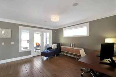 a living room with a blue chair and a desk at Great West Vancouver house with hot tub, across from beach & 10 mn to Downtown Vancouver in West Vancouver