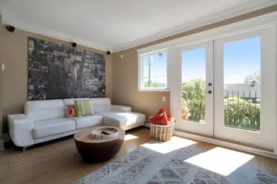 a living room with a couch and a table at Great West Vancouver house with hot tub, across from beach & 10 mn to Downtown Vancouver in West Vancouver