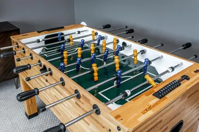 a large wooden box with a game of oars at Amazing Luxe Home, AC, HUGE Yard, FirePit, Pet Friendly, Sleeps 10! in Edmonton