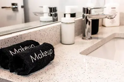 a bathroom counter with a sink and a black mitt sidx sidx sidx at Nordic Retreat, 4BR, Min to WEM & DT, AirCon & Fireplace, Sleeps 10! in Edmonton