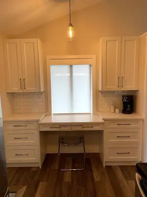 a kitchen with white cabinets and a desk with a window at Escape to Spring Gate Estate in Victoria