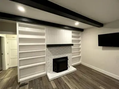 a living room with a fireplace and a flat screen tv at Escape to Spring Gate Estate in Victoria