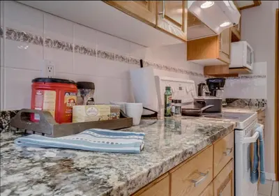 a kitchen with a marble counter top with a stove at Big family home w/ Deck, Ping Pong, BBQ & Garage in Edmonton