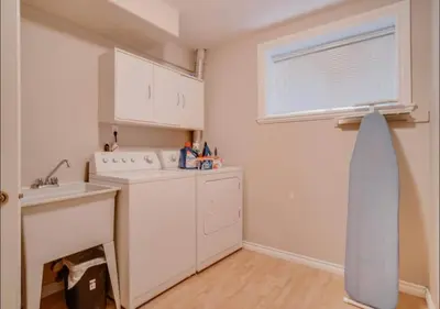 a kitchen with a sink and a dishwasher at Big family home w/ Deck, Ping Pong, BBQ & Garage in Edmonton