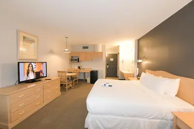 a hotel room with a bed and a television at Prime Hotel in Fort McMurray