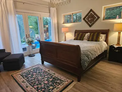 a bedroom with a large bed and a large window at luxury ocean dock pool villa in Ladysmith