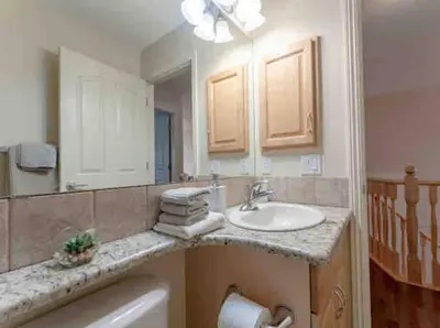 a bathroom with a sink and a mirror at 2500 sq house in Springbank Hill BL 261818 in Calgary