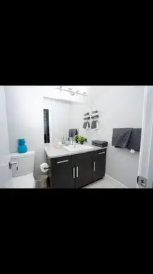 a bathroom with a sink and a toilet at Cozy and beautiful 3 bedroom house close to lake in Edmonton
