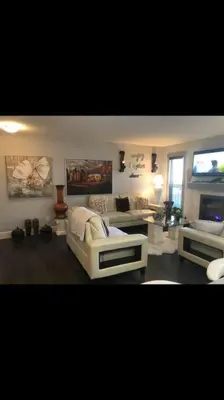 a living room with a couch and a tv at Cozy and beautiful 3 bedroom house close to lake in Edmonton