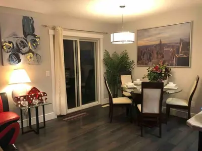 a living room with a table and a dining room at Cheerful and beautiful 3 bedroom home close lake in Edmonton