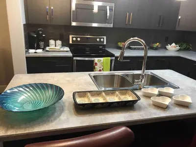 a kitchen counter with a sink and a bowl and a plate at Cheerful and beautiful 3 bedroom home close lake in Edmonton