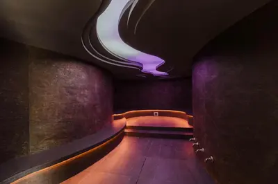 a dark hallway with a purple light on the ceiling at Everwild Canmore Hotel in Canmore