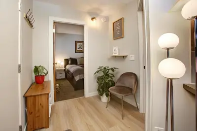 a bedroom with a bed and a chair in a room at Gondola Haus - Free parking in Whistler