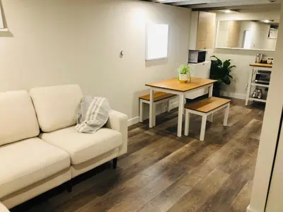 a living room with a couch and a table at Trendy Kensington 3 min Walk Backyard AC Garage in Calgary