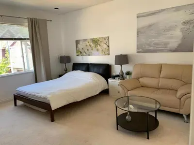 a bedroom with a bed and a couch at Xin Xin House in Richmond