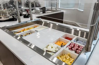 a kitchen with several trays of food at Staybridge Suites - Dawson Creek by IHG in Dawson Creek