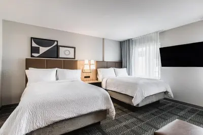 a hotel room with two beds and a window at Staybridge Suites - Dawson Creek by IHG in Dawson Creek