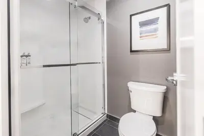 a bathroom with a toilet and a glass shower at Staybridge Suites - Dawson Creek by IHG in Dawson Creek
