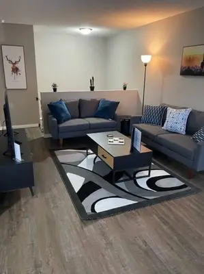 a living room with two couches and a coffee table at Wonderful 2-bedroom apartment in Camrose