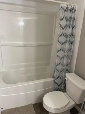 a bathroom with a toilet and a shower curtain at Wonderful 2-bedroom apartment in Camrose