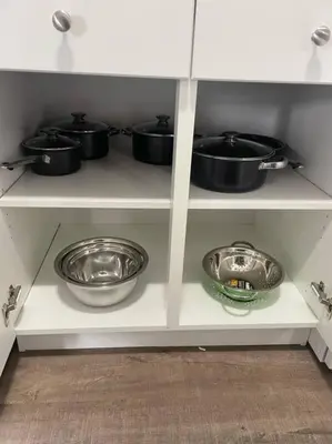 a kitchen shelf with pots and pans on it at Wonderful 2-bedroom apartment in Camrose