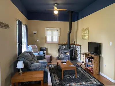 a living room with a couch and a fireplace at Witt's End Ranch Private Get Away in Princeton
