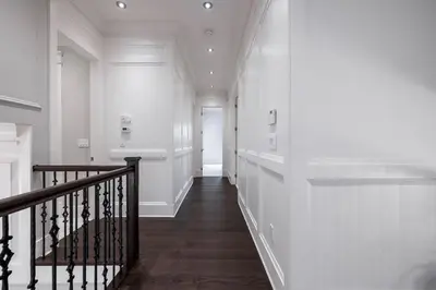 a hallway of a home with white walls and a staircase at Luxurious Private Rooms in Richmond in Richmond