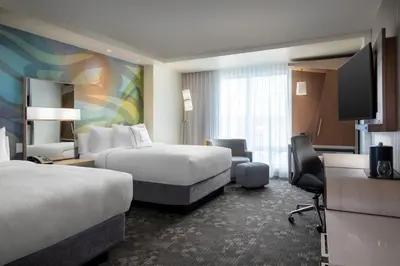 a hotel room with two beds and a flat screen tv at Courtyard by Marriott Nanaimo in Nanaimo