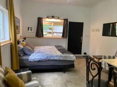 a bedroom with a bed and a window at Battle Creek Ranch, Wells Gray Park in Clearwater