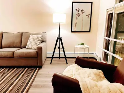a living room with a couch and a table at unit #301 Mountain view 2BR in Canmore Down town in Canmore