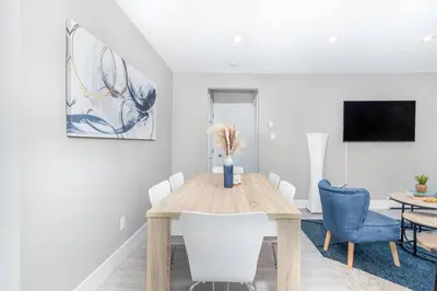 a dining room with a wooden table and chairs at Modern & Stylish 1-Bedroom Unit in Edmonton